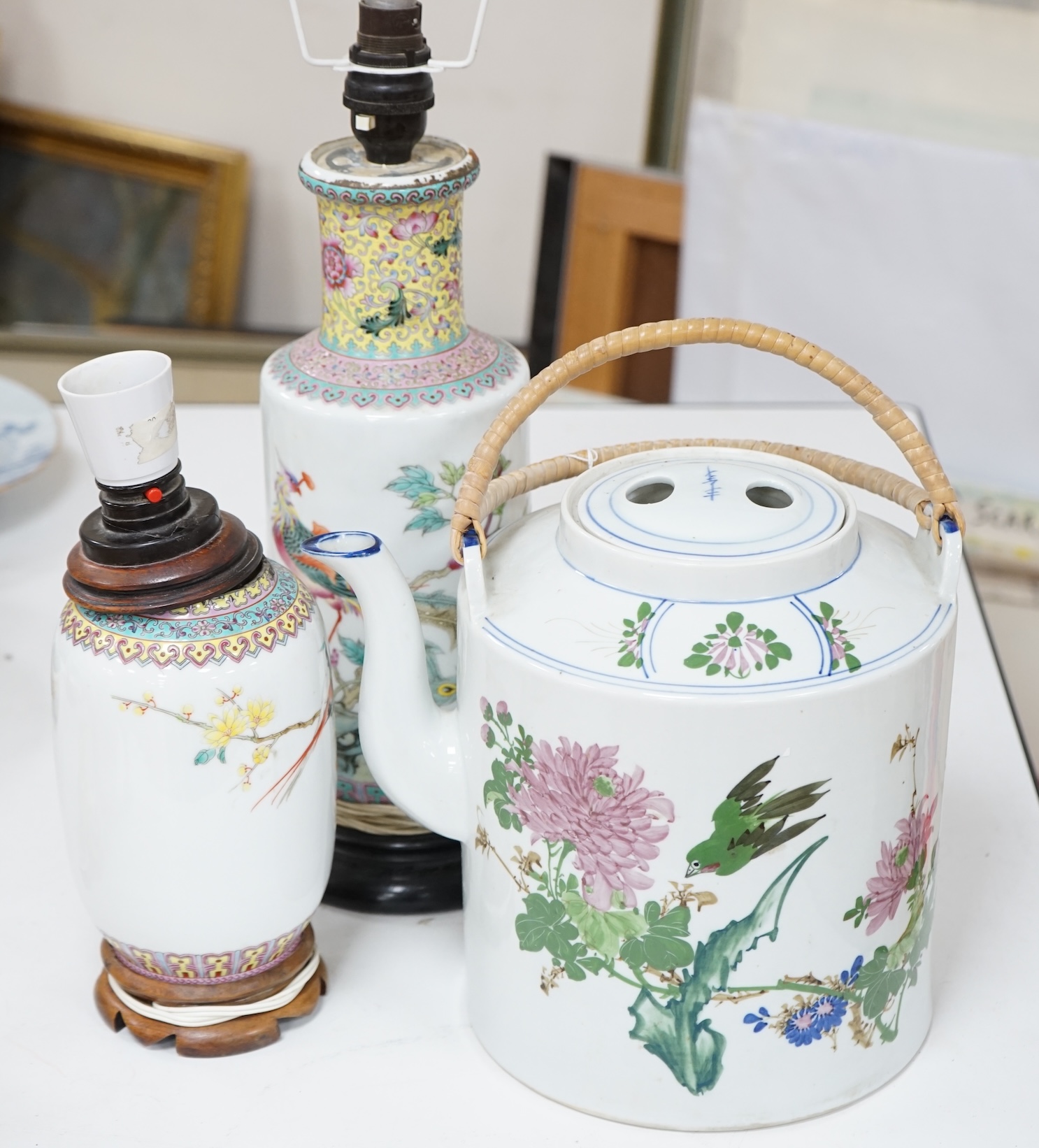 Two early 20th century Chinese famille rose lamps and a large teapot. Condition - fair